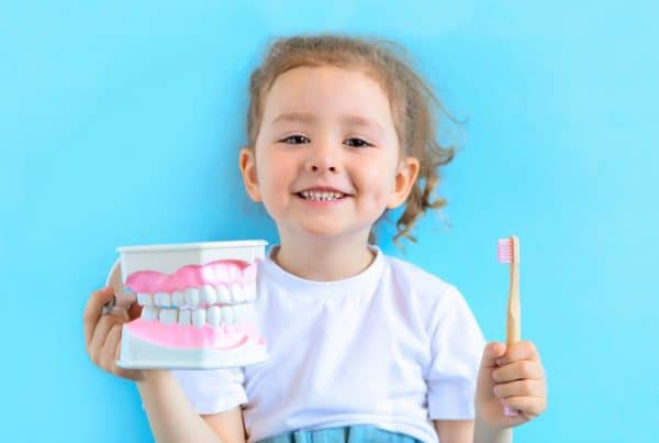 Smiling girl practicing oral health.